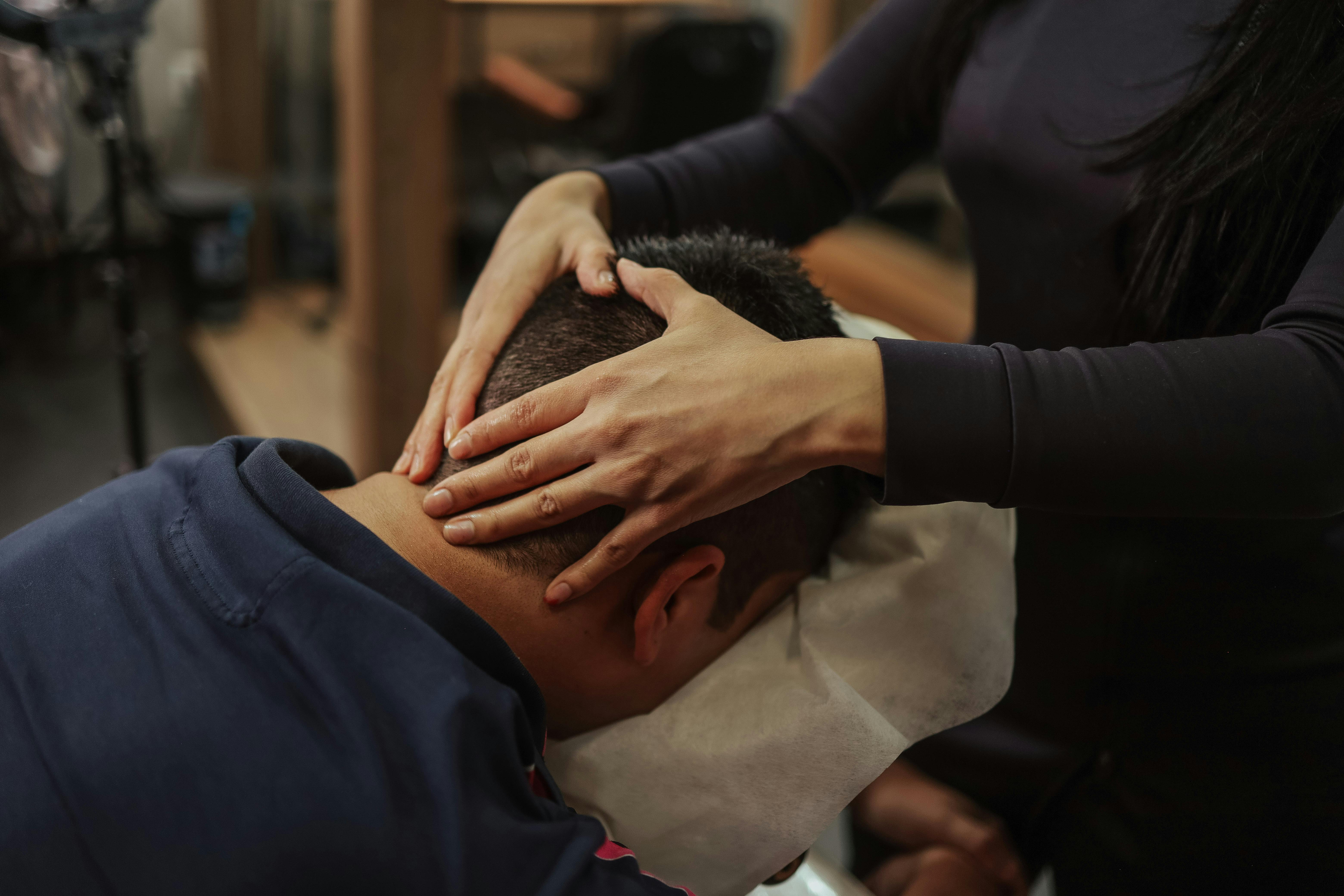 Office worker receiving on-site chair-massage. In-office therapeutic bodywork. Community wellness partnerships.
