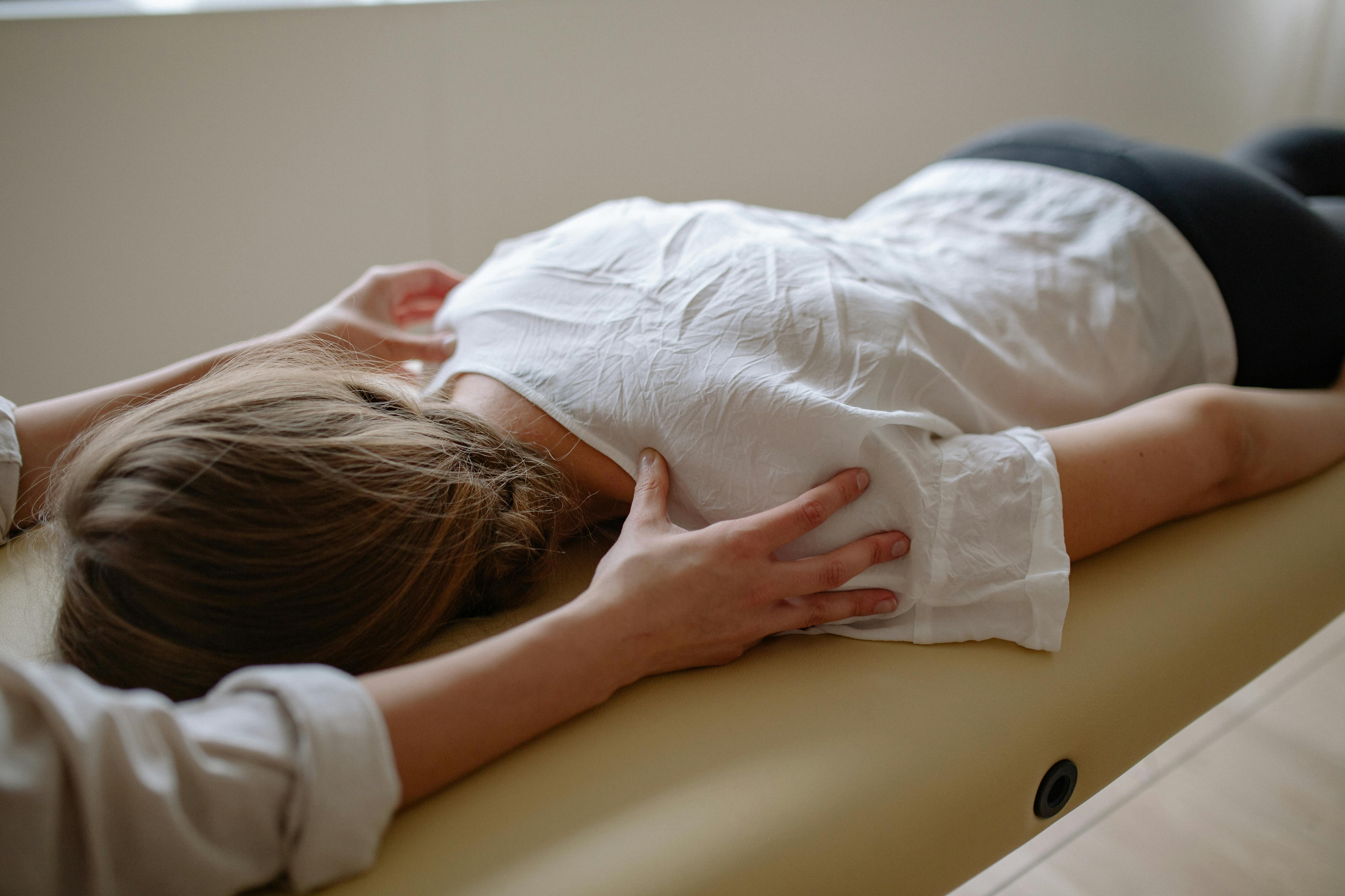Lady receiving a therapeutic massage treatment lying face down on a table in Westchester County, NY.